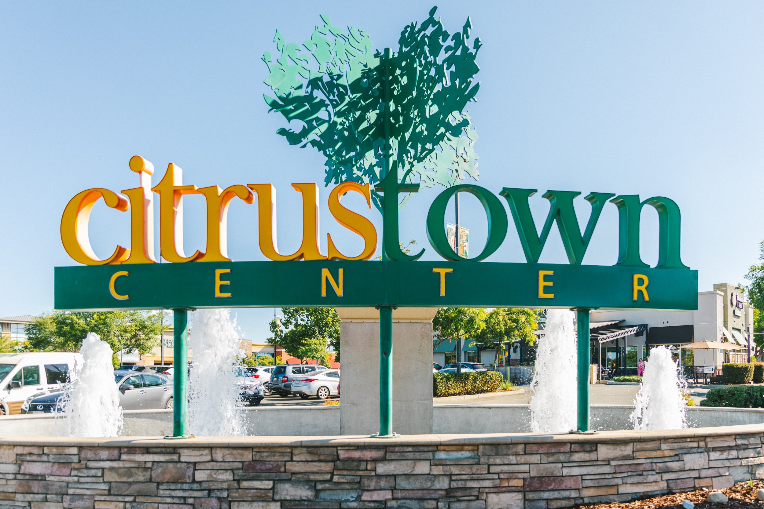 Photo of Citrus Town Center's main signage on a sunny day with a decorative fountain behind it.